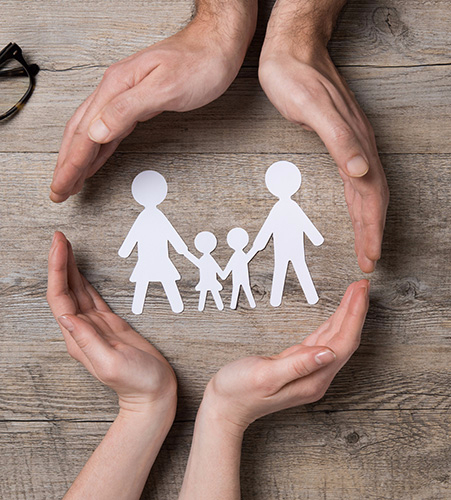 hands surrounding a paper doll family representing Estate and Trust Planning